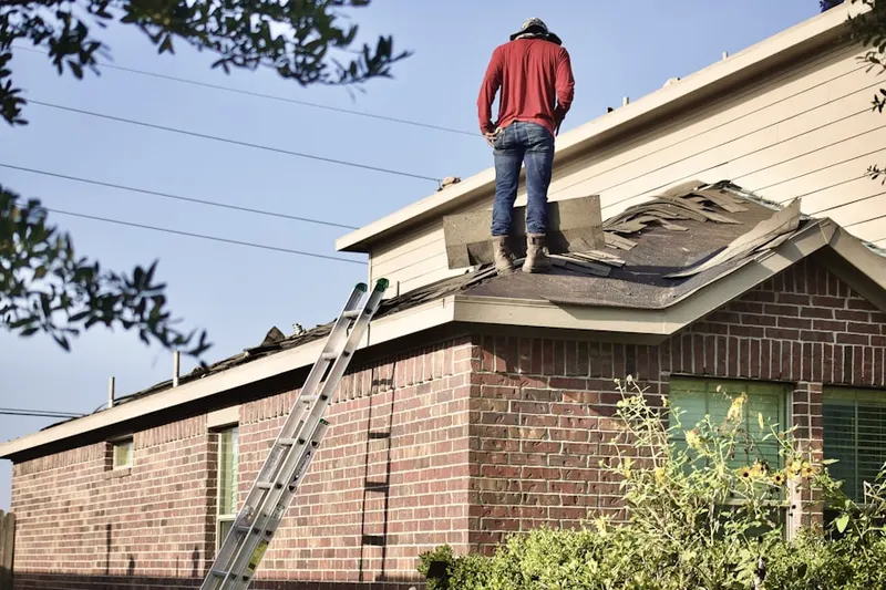 Professional roofer working on a residential roof in Cedar Village